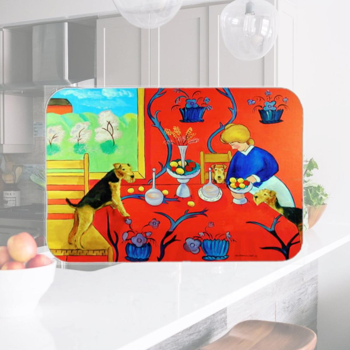 Picture of Carolines Treasures 7212LCB 15 x 12 in. Airedale Terrier with lady in the kitchen Glass Cutting Board- Large