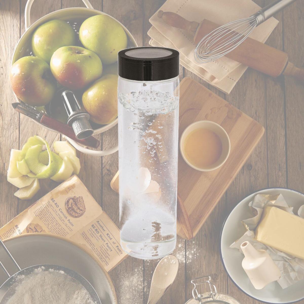 Picture of Debco WB1503 600 ml 20 oz Single Wall Glass Bottle - Clear Glass Bottle / Black Lid