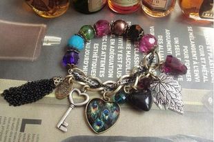 B0007 Vintage Colored Beaded Bracelet With Peacock Feather Charms