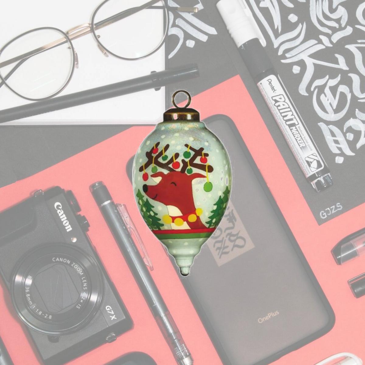 Picture of HomeRoots 477465 Festive Glitter Reindeer with Lights Hand Painted Mouth Blown Glass Ornament, Multi Color