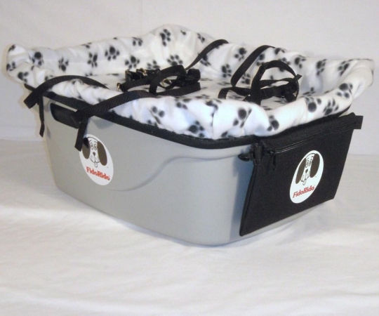 FidoRido tan two-seater with light-weight fleece in black with tan dog bones and a small harness and dog kennel