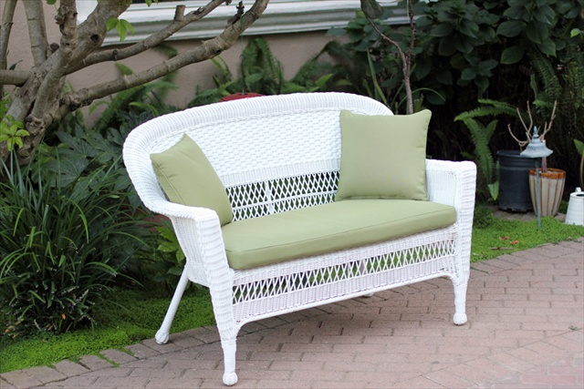 White Wicker Patio Love Seat With Green Cushion And Pillows