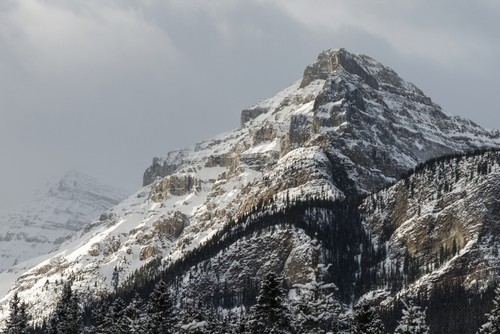 Rugged Mountain Peak with Snow Under A Cloudy Sky - Lake Louise Alberta Canada Poster Print by Keith Levit - 38 x 24 - Large