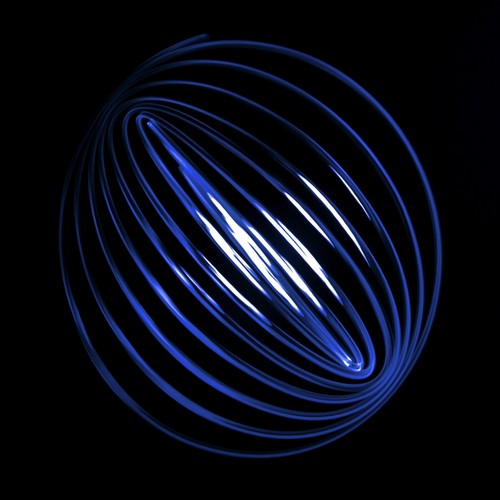 Blue Light Curving into A Sphere Shape Against A Black Background Poster Print by Nick Dale, 24 x 24 - Large
