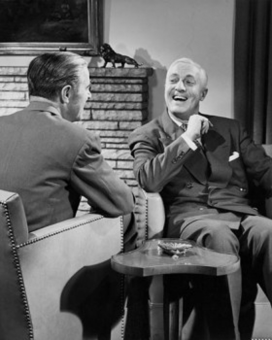 Two Businessmen Talking Indoors Poster Print - 18 x 24 in.