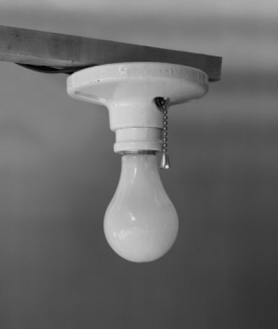 Close-Up of a Lit Light Bulb Poster Print - 18 x 24 in.