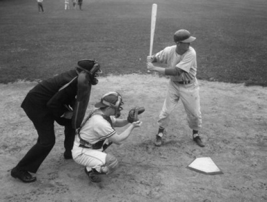 Baseball Player Swinging a Baseball Bat with a Baseball Catcher & a Baseball Umpire Beside Him Poster Print - 18 x 24 in.