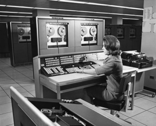 Businesswoman Working on a Mainframe Computer in an Office Poster Print - 18 x 24 in.