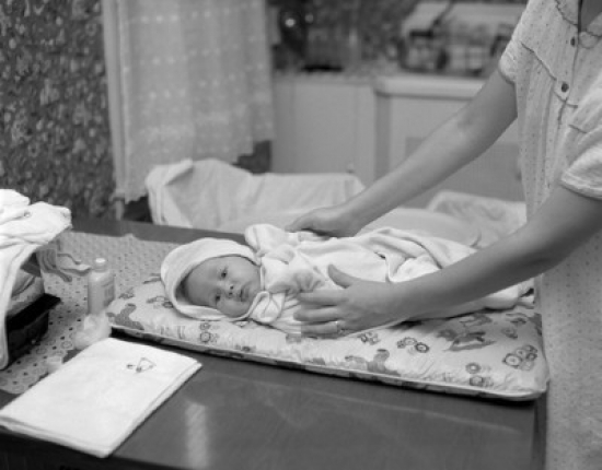 Mother Nursing Baby on Table Poster Print - 18 x 24 in.