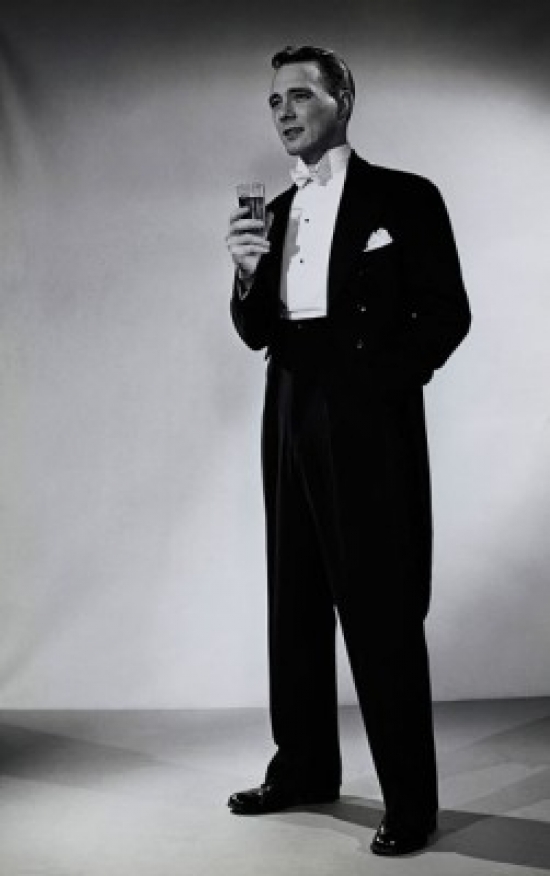 Young Man Standing & Holding a Glass Poster Print - 18 x 24 in.