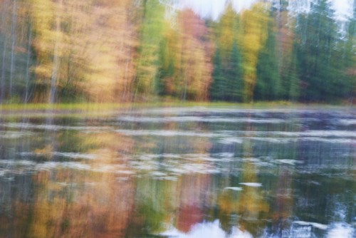 Blurred Autumn Coloured Trees Along The Shoreline Reflected in a Tranquil River - Ontario Canada Poster Print by Ian Crysler, 38 x 24 - Large