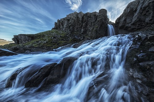 DPI12296400LARGE A Small Waterfall Flows into The Ocean Along The Eastern Coast of Iceland - Poster Print by Robert Postma, 36 x 24 - Large