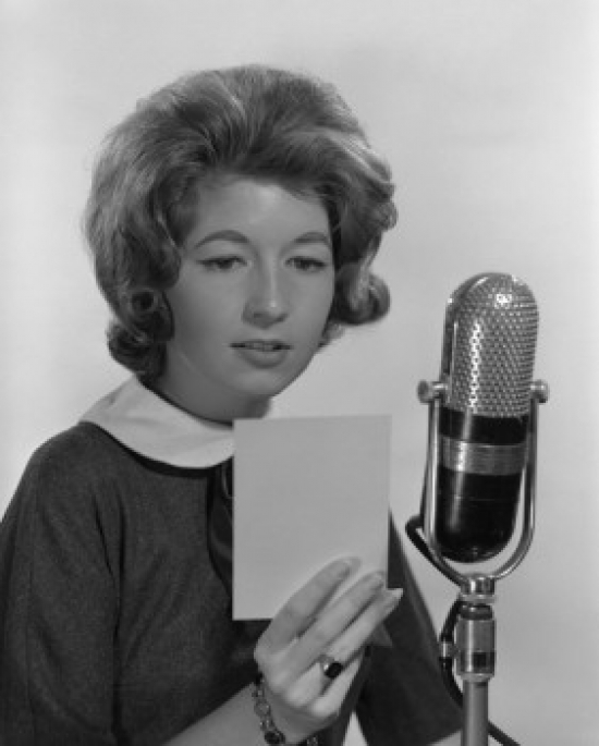 Young Woman Reading Into Microphone Poster Print - 18 x 24 in.