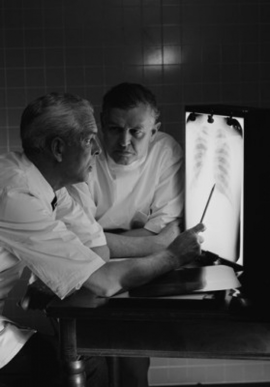 Doctors Examining X-Ray Poster Print - 18 x 24 in.