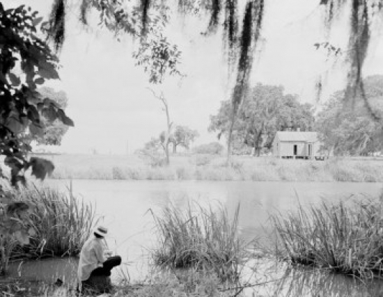 Man Sitting on Riverbank Poster Print - 18 x 24 in.