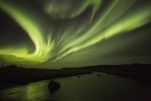 DPI12296412 Northern Lights Or Aurora Borealis Glowing Over A Stream - Iceland Poster Print by Robert Postma, 19 x 12