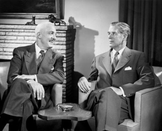Two Businessmen Talking Indoors Poster Print - 18 x 24 in.