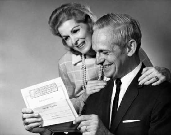 Senior Couple Reading a Document & Smiling Poster Print - 18 x 24 in.