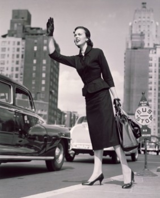 Low Angle View of a Young Woman Hailing a Taxi Poster Print - 18 x 24 in.