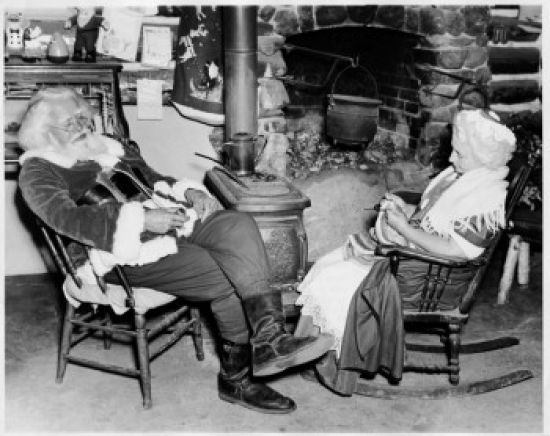SAL255690 Side Profile of Santa Claus Sitting with a Senior Woman Near a Fireplace Poster Print - 18 x 24 in.
