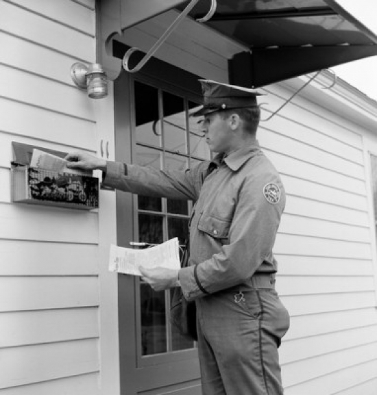 Side Profile of a Postman Dropping Mail in a Mailbox Poster Print - 18 x 24 in.