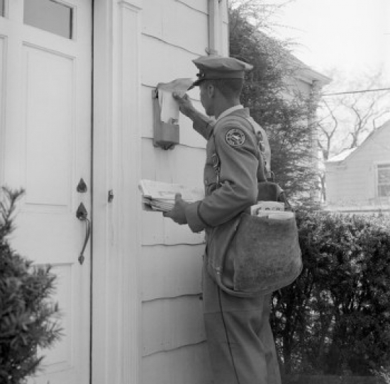 Side Profile of a Postman Dropping Mail in a Mailbox Poster Print - 18 x 24 in.