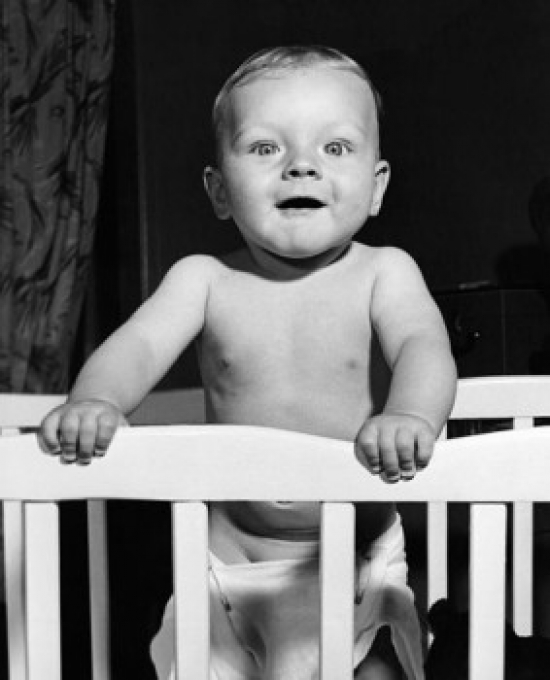 Baby Standing in a Crib Poster Print - 18 x 24 in.