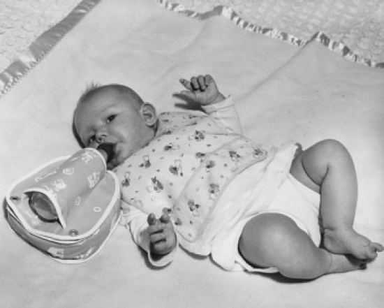 High Angle View of a Baby Lying on a Blanket & Drinking Milk From a Bottle Poster Print - 18 x 24 in.