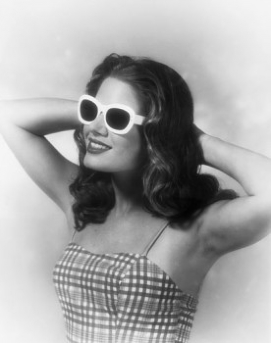 Close-Up of a Young Woman Smiling with Her Hands Behind Her Head Poster Print - 18 x 24 in.