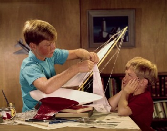 Two Boys Assembling a Model of Sailboat Poster Print - 18 x 24 in.