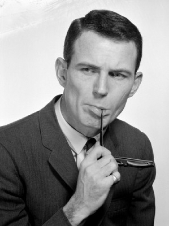 Pensive Businessman Biting Glasses Poster Print - 18 x 24 in.