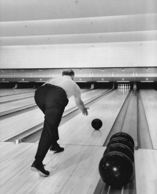 Man Rolling a Bowling Ball Down a Lane Poster Print - 18 x 24 in.