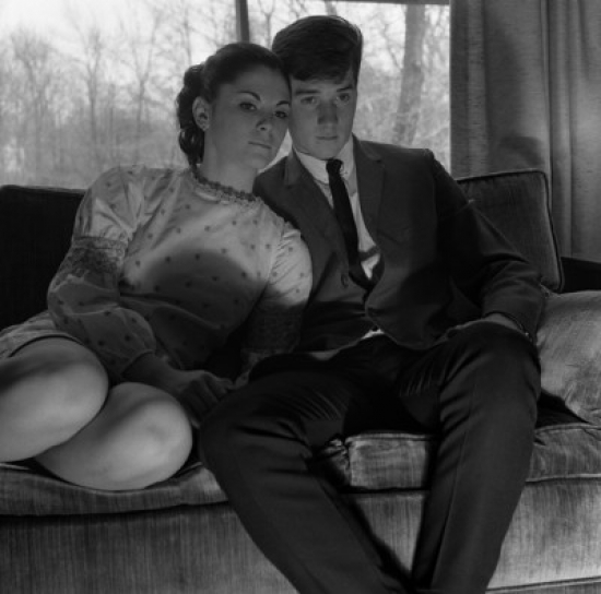 Young Couple Watching TV on Sofa Poster Print - 18 x 24 in.
