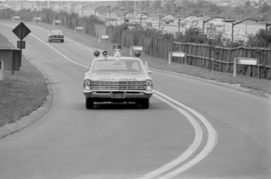 Police Car on Road Poster Print - 18 x 24 in.