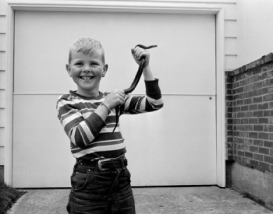 Boy Holding Garter Snake Poster Print - 18 x 24 in.