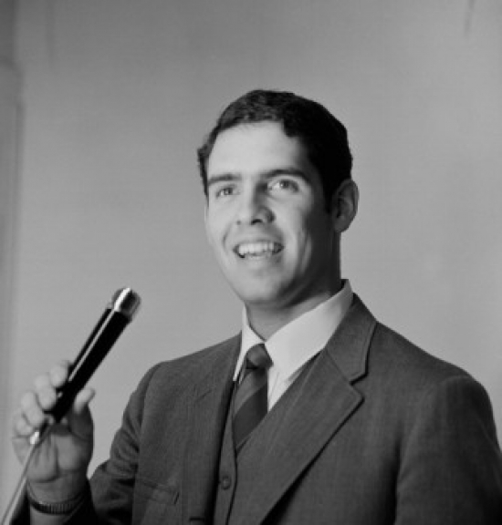 Young Man Holding Microphone Poster Print - 18 x 24 in.