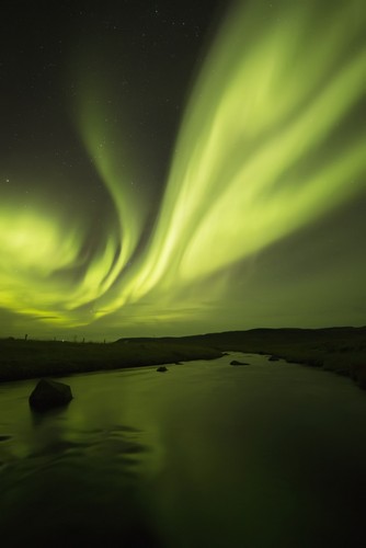 DPI12296411 Northern Lights Or Aurora Borealis Glowing Over A Stream - Iceland Poster Print by Robert Postma, 12 x 19
