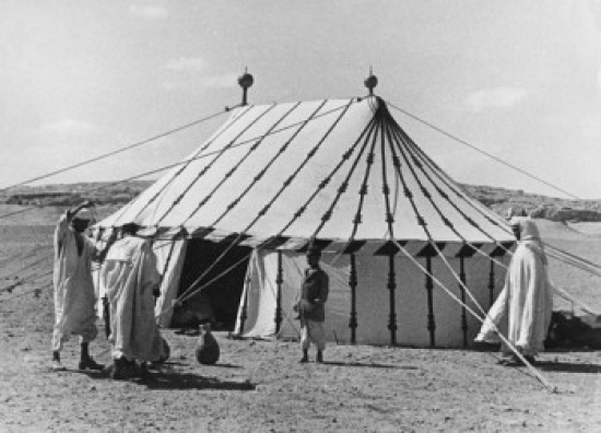 Men Building Tent on Desert Boy Watching Them Poster Print - 18 x 24 in.