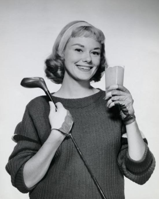 SAL25550076 Portrait of a Young Woman Holding a Glass of Juice & a Golf Club Poster Print - 18 x 24 in.