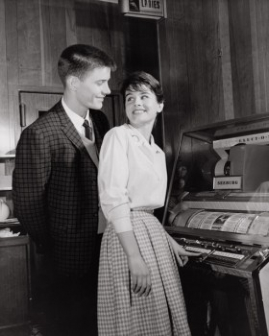 SAL2555827 Side Profile of a Teenage Couple Standing Near a Jukebox Poster Print - 18 x 24 in.