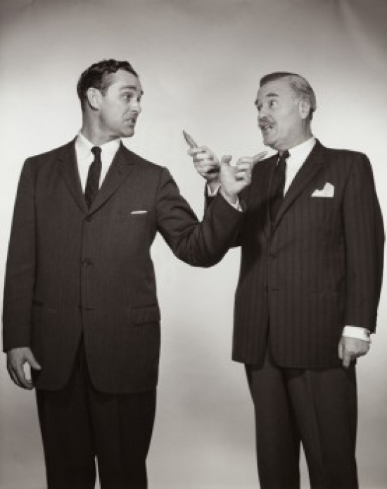 Two Businessmen Pointing at Each Other Poster Print - 18 x 24 in.