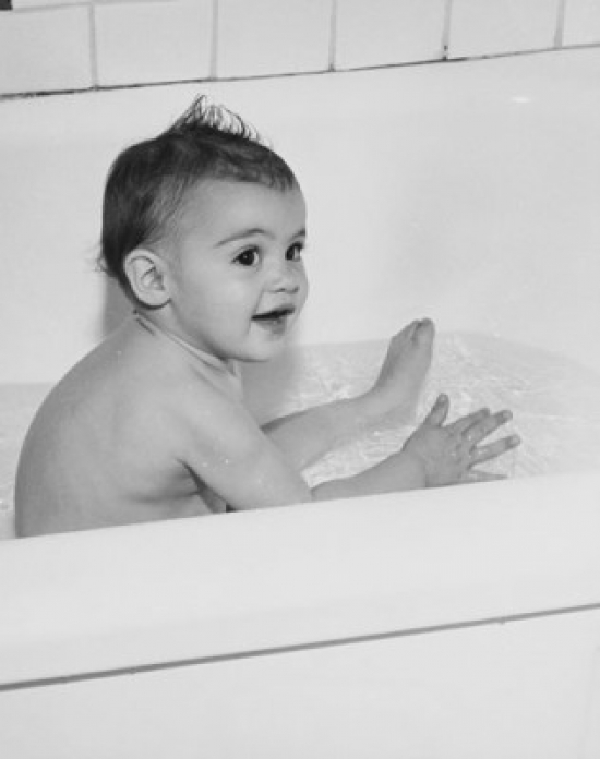 Baby Bathing in a Bathtub Poster Print - 18 x 24 in.