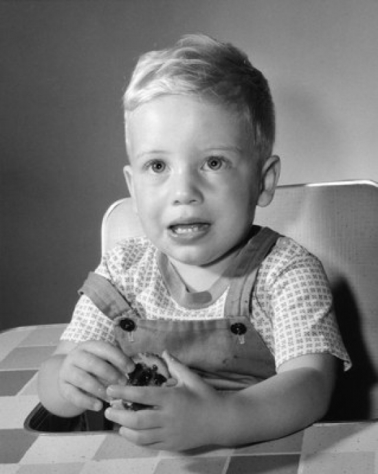 Little Boy Holding Biscuit Poster Print - 18 x 24 in.