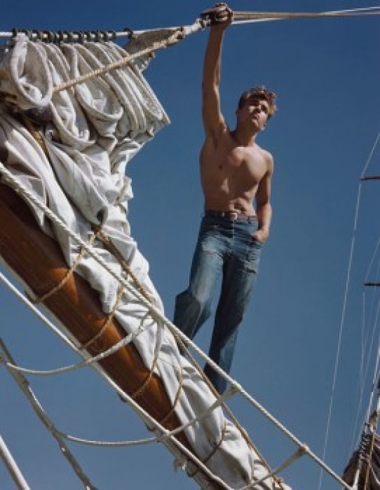 Low Angle View of a Young Man Standing on a Pole on a Sailing Ship Poster Print - 18 x 24 in.