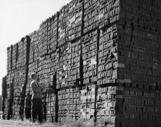 Man Examining Bricks in a Brickyard Poster Print - 18 x 24 in.