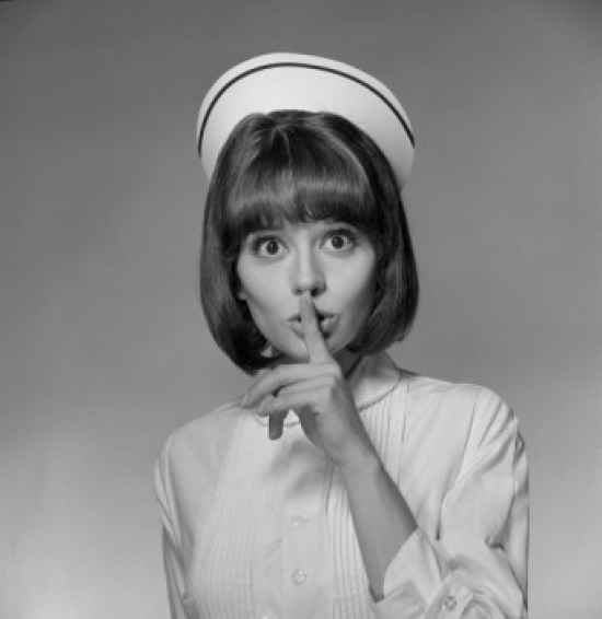 Young Nurse with Finger on Lips Poster Print - 18 x 24 in.