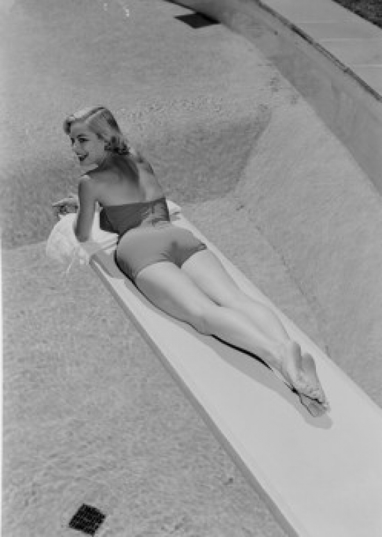 SAL255419031 Young Woman in Swimwear Lying on Diving Board Poster Print - 18 x 24 in -  Posterazzi