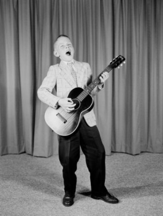 Boy Playing Guitar on Stage Poster Print - 18 x 24 in.