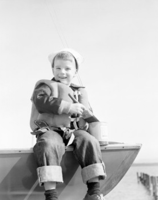 Boy Sitting on Boat Smiling Poster Print - 18 x 24 in.