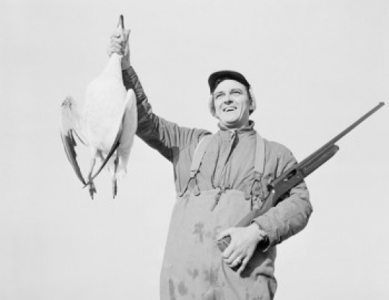 Hunter Holding Dead Snow Goose Poster Print - 18 x 24 in.